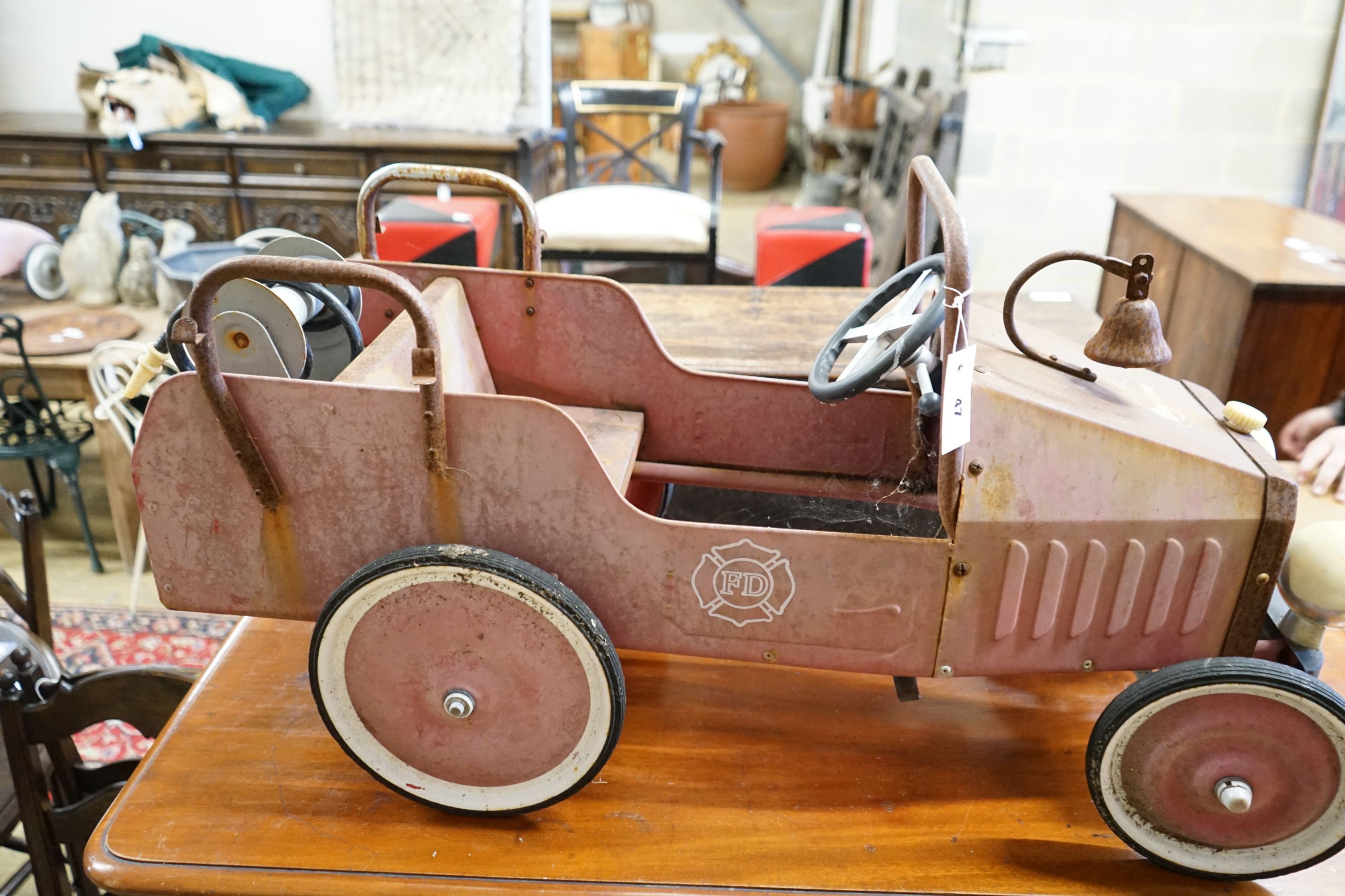 A child's tin plate pedal ride on toy fire engine, length 95cm